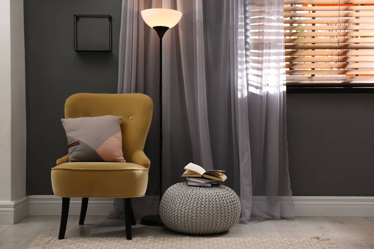 Horizontal window blinds with drapes in a living room at Cindy's & Bolliger Window Fashions near Gresham, OR