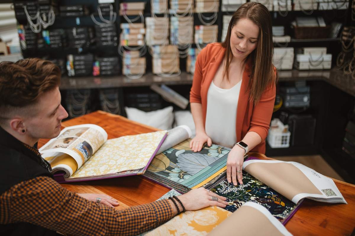 Kaela and Andrew looking over fabric sample books